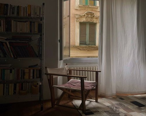 Italian window with soft daylight highlighting a reading corner